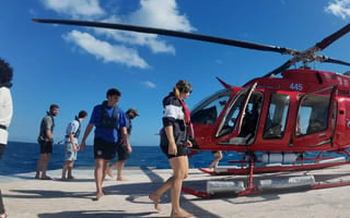 A helicopter on a reef pontoon with the Coral Sea behind