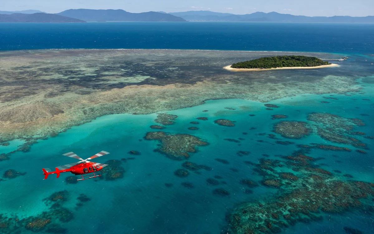 A helicopter over a sand cay on the Great Barrier Reef